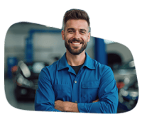 Smiling man in blue uniform at car dealership with POS system in background.