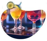 Assorted vibrant cocktails served in decorative glasses at a bar.